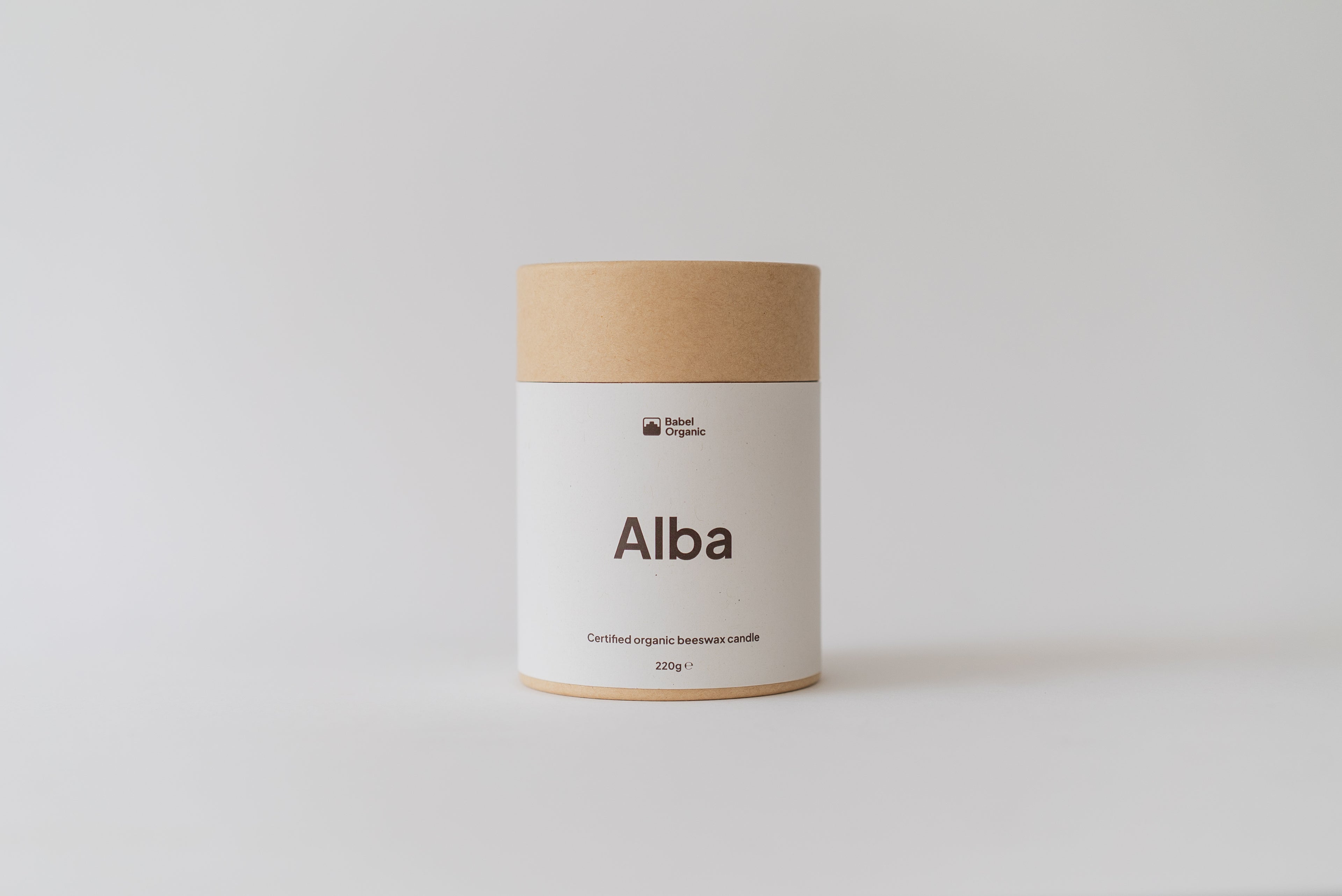 A cylindrical kraft paper jar candle labeled 'Alba' by the brand Local Papers, set against a clean, light gray studio background.