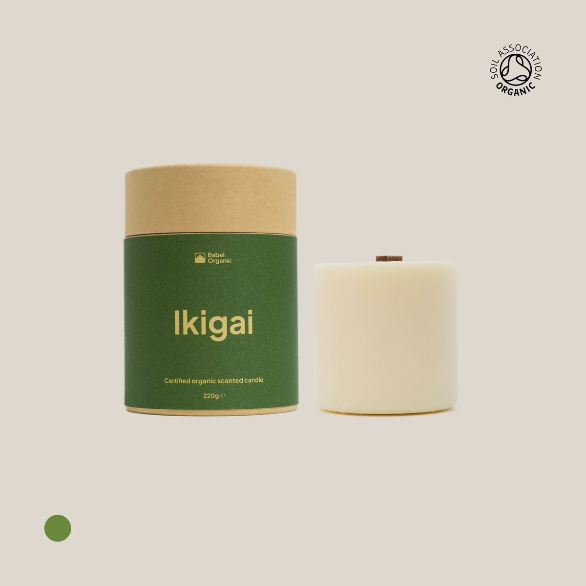 Green Ikigai candle with candle refill on a beige background.