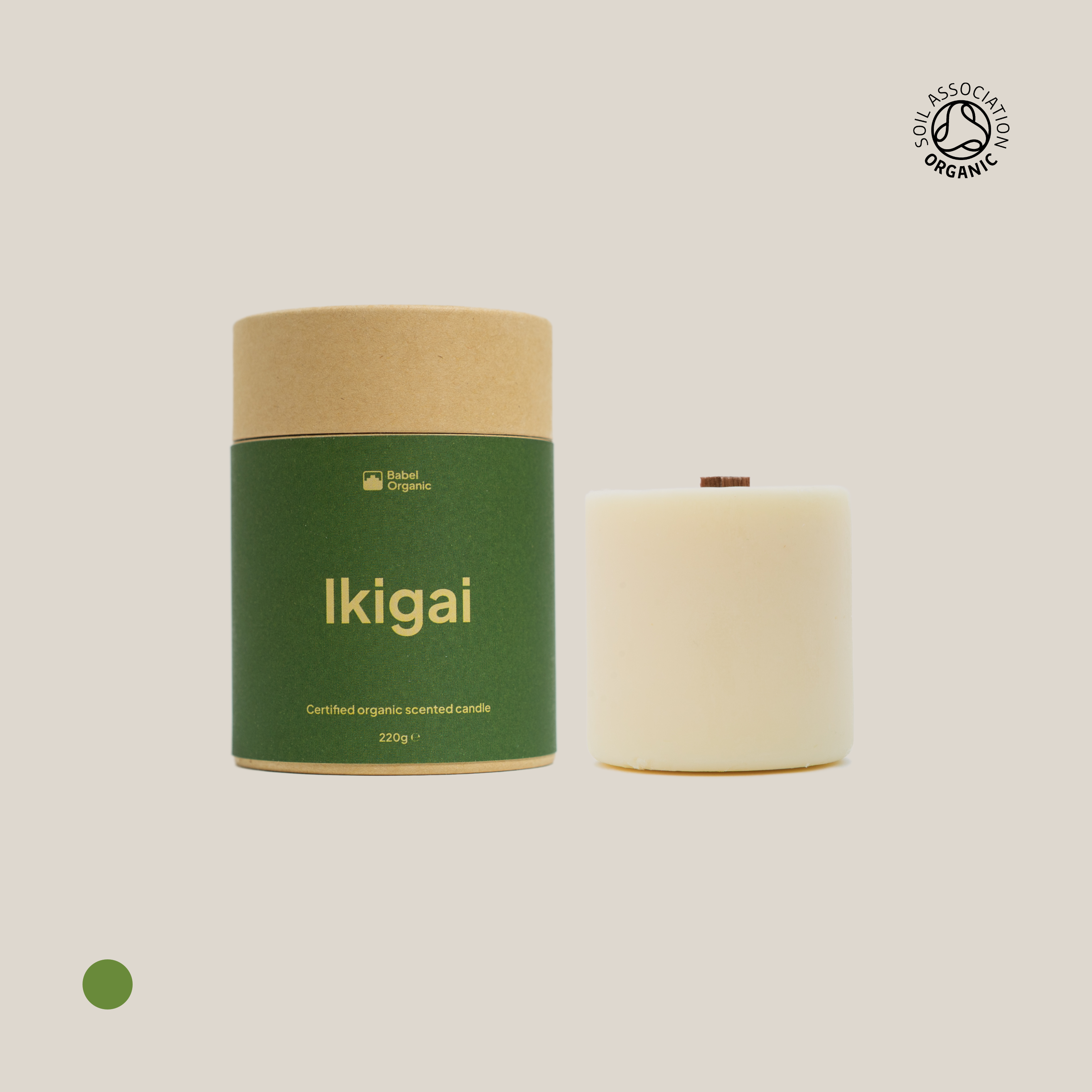Green Ikigai candle with candle refill on a beige background.