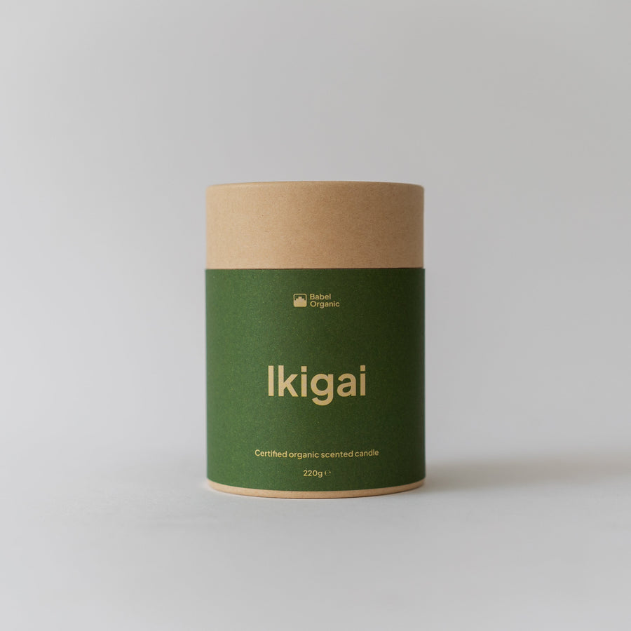 A cylindrical kraft paper canister with a dark green label reading 'Ikigai' in gold lettering, set against a plain light gray background.