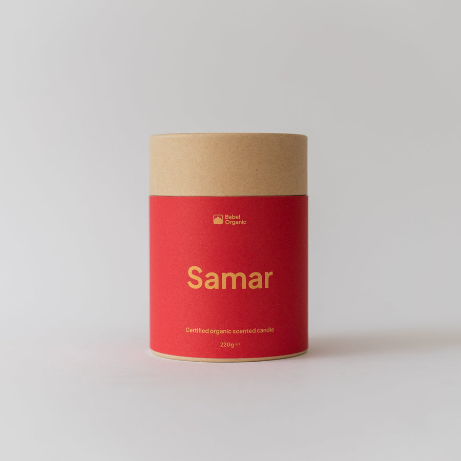 A cylindrical cardboard container with a bright red label and natural kraft paper top, labeled 'Samar' in gold text, set against a clean light gray background.