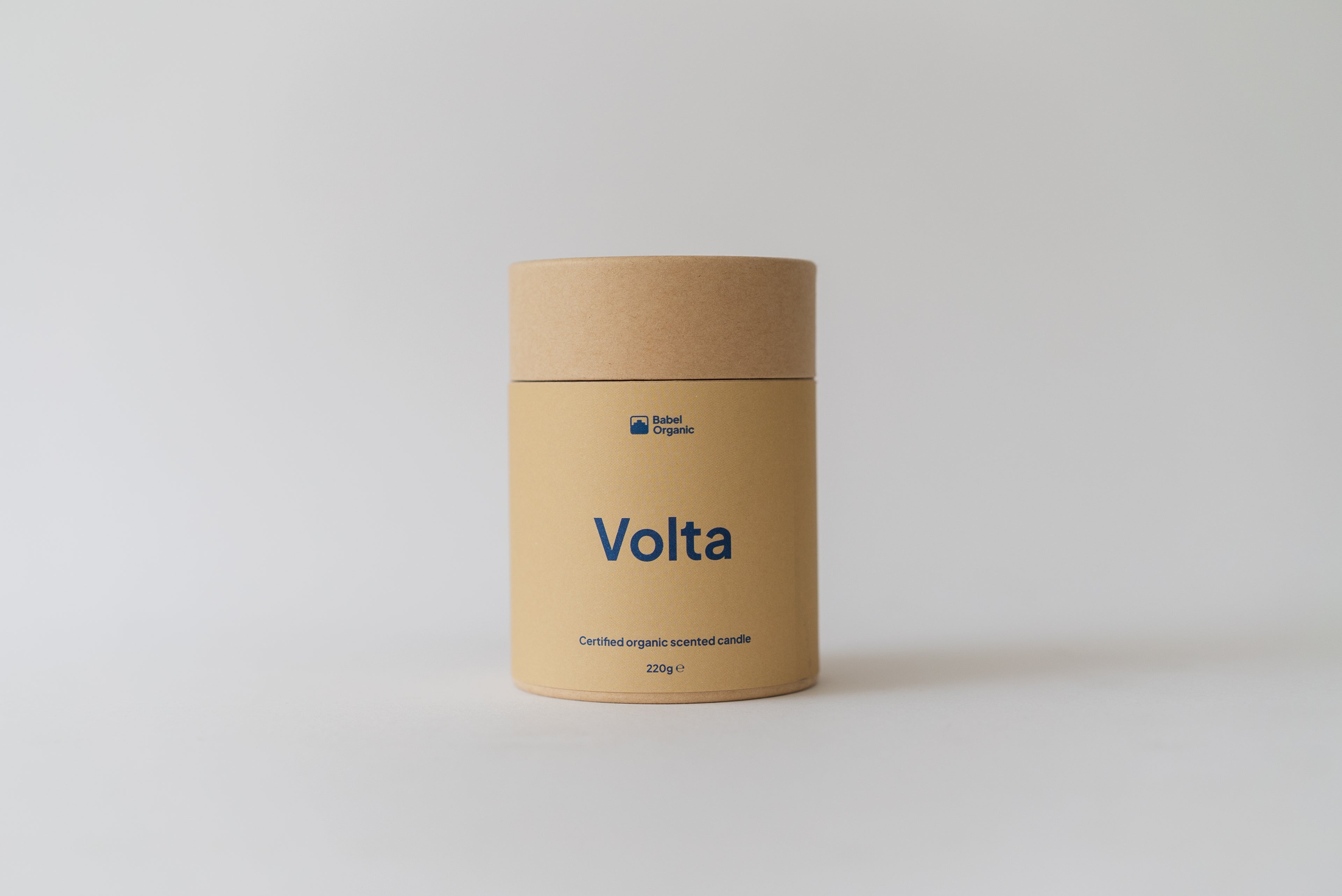 A cylindrical kraft paper container labeled 'Volta' in blue text, photographed against a clean light gray studio background.