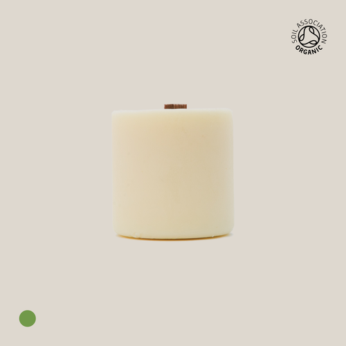 Beige cylindrical candle refill on a beige background with a visible Organic Certification logo